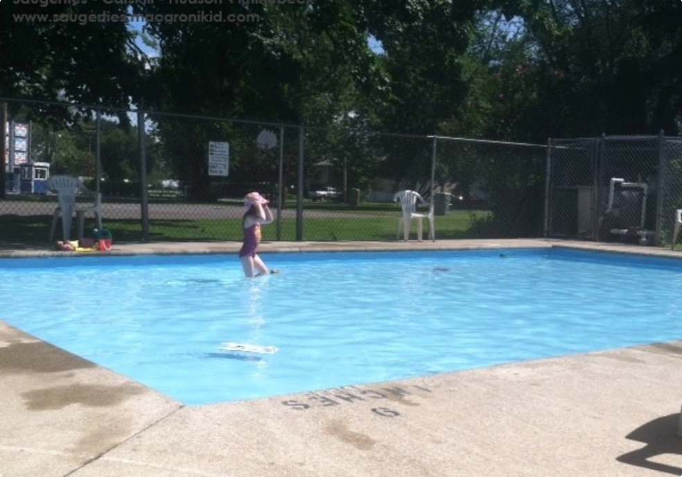 Button showing a Child in the Lions Club Wading Pool.  Photo by Jenna Slade.  Links to the Wading Pool webpage.